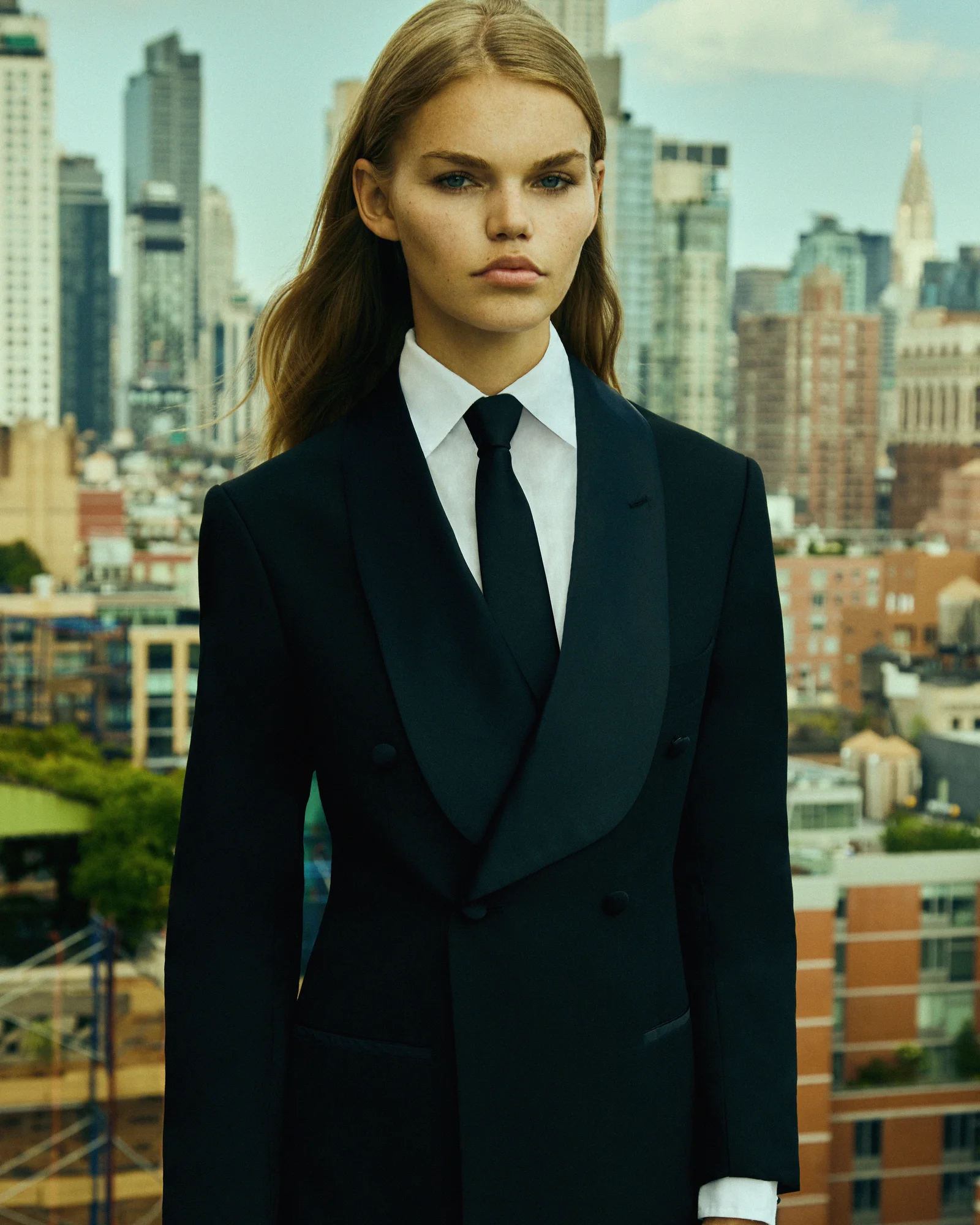 A model in black tailoring on a New York rooftop.